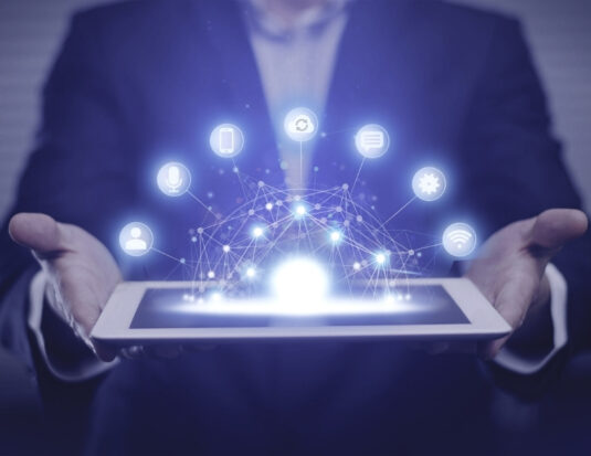 man holding tablet with digital marketing symbols
