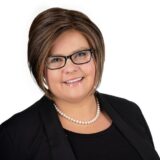 Professional headshot of Jennifer Fox, President of Auto Electric Service Ltd., smiling and wearing glasses and a pearl necklace.