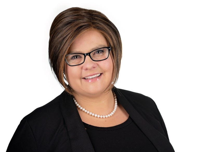 Professional headshot of Jennifer Fox, President of Auto Electric Service Ltd., smiling and wearing glasses and a pearl necklace.