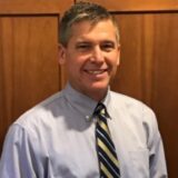 Todd Hammond, the newly appointed Northeast Regional Sales Manager for Akebono Brake Corporation, smiling in a professional headshot wearing a blue shirt and striped tie.
