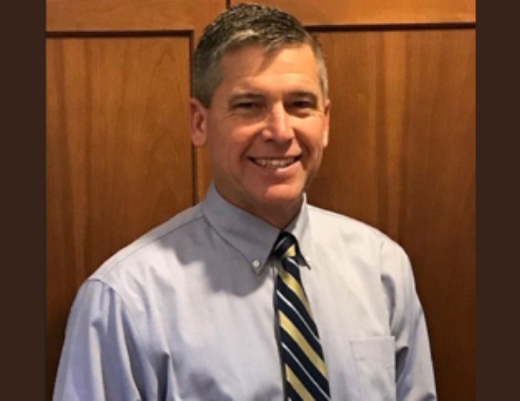 Todd Hammond, the newly appointed Northeast Regional Sales Manager for Akebono Brake Corporation, smiling in a professional headshot wearing a blue shirt and striped tie.