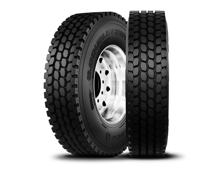 Two Double Coin RLB452 drive tires shown from the side and front to display the tread pattern and sidewall branding.