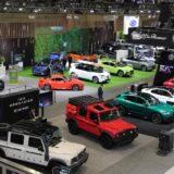 A high-angle view of the 2026 Canadian International AutoShow floor, showcasing a wide variety of vehicles from brands such as INEOS Grenadier, Alfa Romeo, and Subaru on display for attendees.