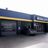 Exterior of the NAPA AUTOPRO Upper James automotive service building featuring blue and yellow branding and service bays.