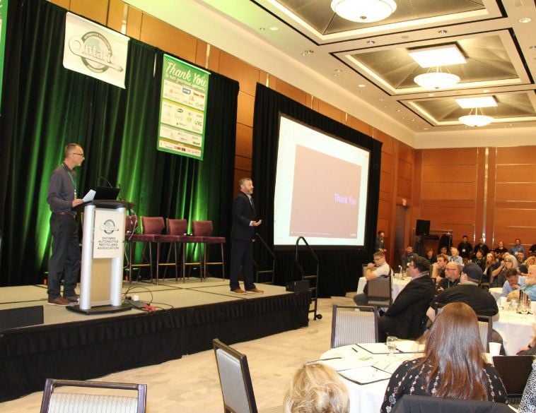 A speaker stands on a stage with a podium and large screen during a presentation at the OARA Convention 2026, where over 430 attendees gathered for the association's best-attended event on record.