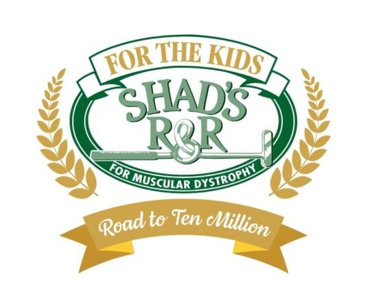 A charity logo with gold and green elements. An upper gold banner reads "FOR THE KIDS". A large green oval frames "SHAD'S R&R" with a crossed golf club and the text "FOR MUSCULAR DYSTROPHY". Gold wheat stalks frame the sides, and a lower gold banner reads "Road to Ten Million".